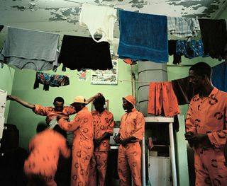 Prisoners and clothes hanging on indoor clothes line