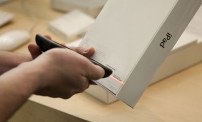 An Apple employee scans the iPad2 bar code: Rumors that the iPad 3 will launch after the new year may have customers holding out for the upgrade.