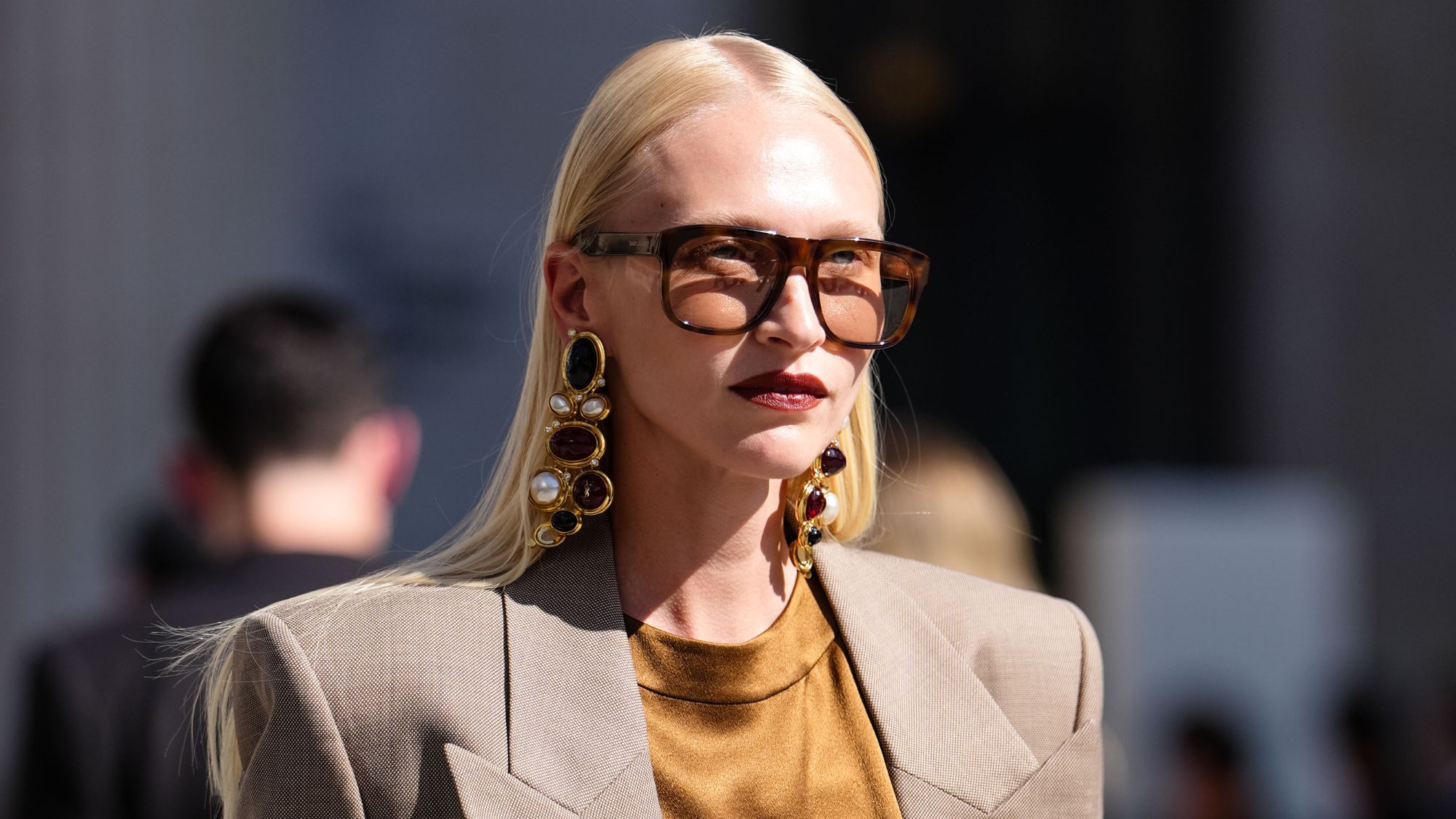 woman with beige blazer with sunglasses on