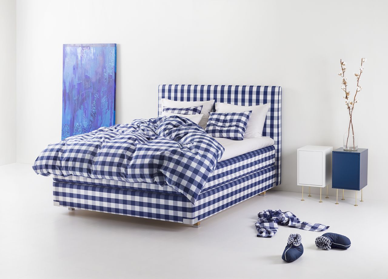 Hästens 2000T bed in blue check in bedroom with accessories