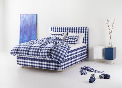 Hästens 2000T bed in blue check in bedroom with accessories