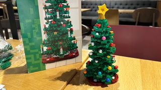 Lego Christmas Tree next to box on wooden table