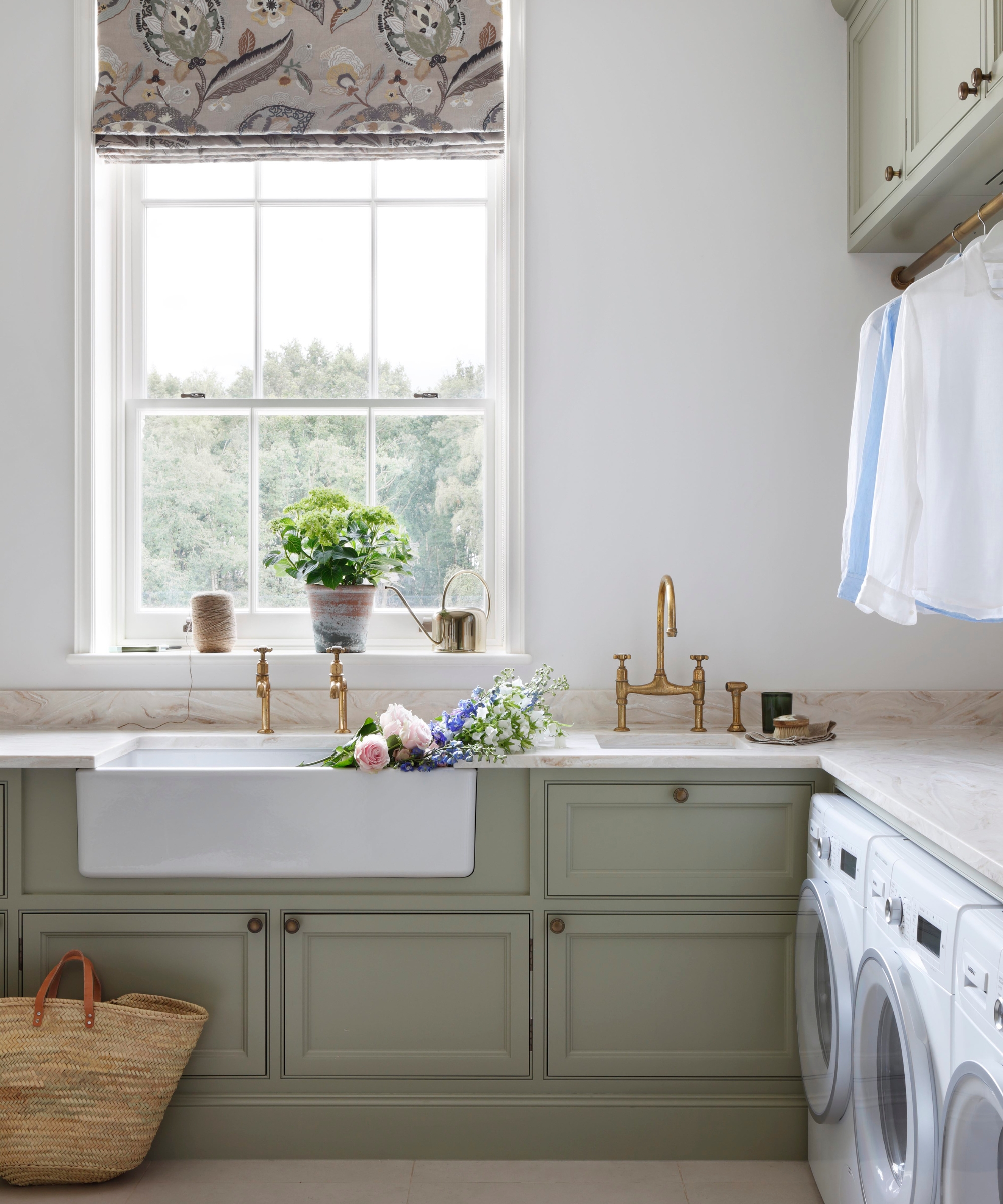 A laundry room with white walls and Farrow &amp;amp; Ball's French Grey for the cabinetry