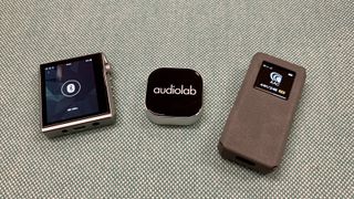 FiiO BTR7, Audiolab M-DAC Nano and Hidizs AP80 Pro-X side by side on blue background