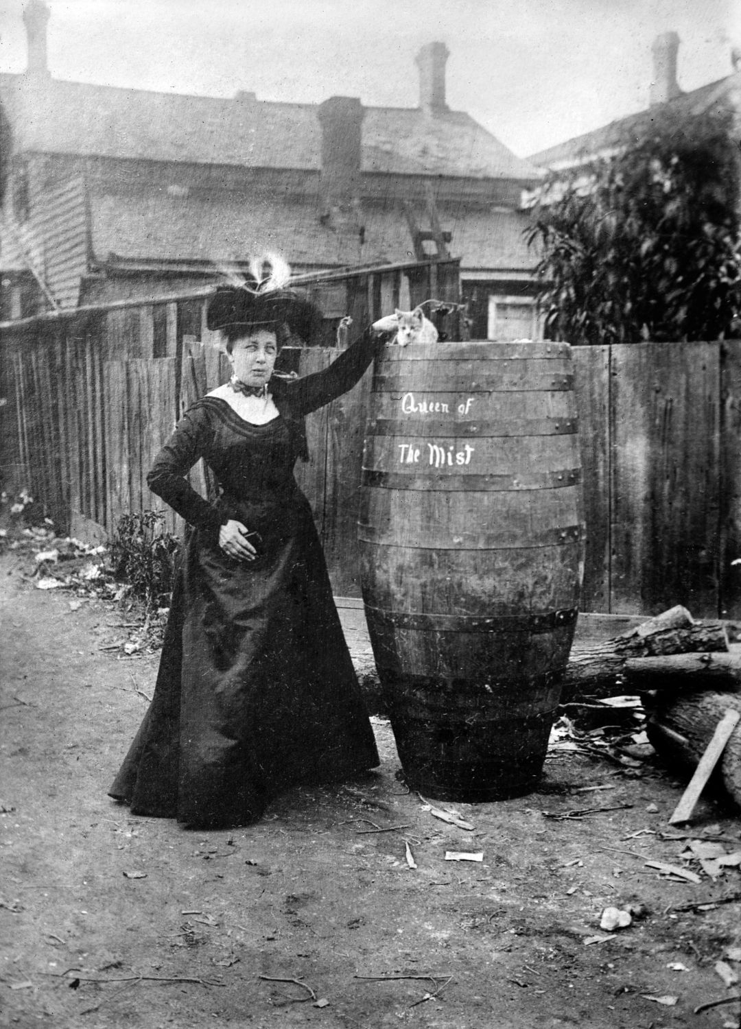 A black and white photo of AnnieTaylor next to a barrel