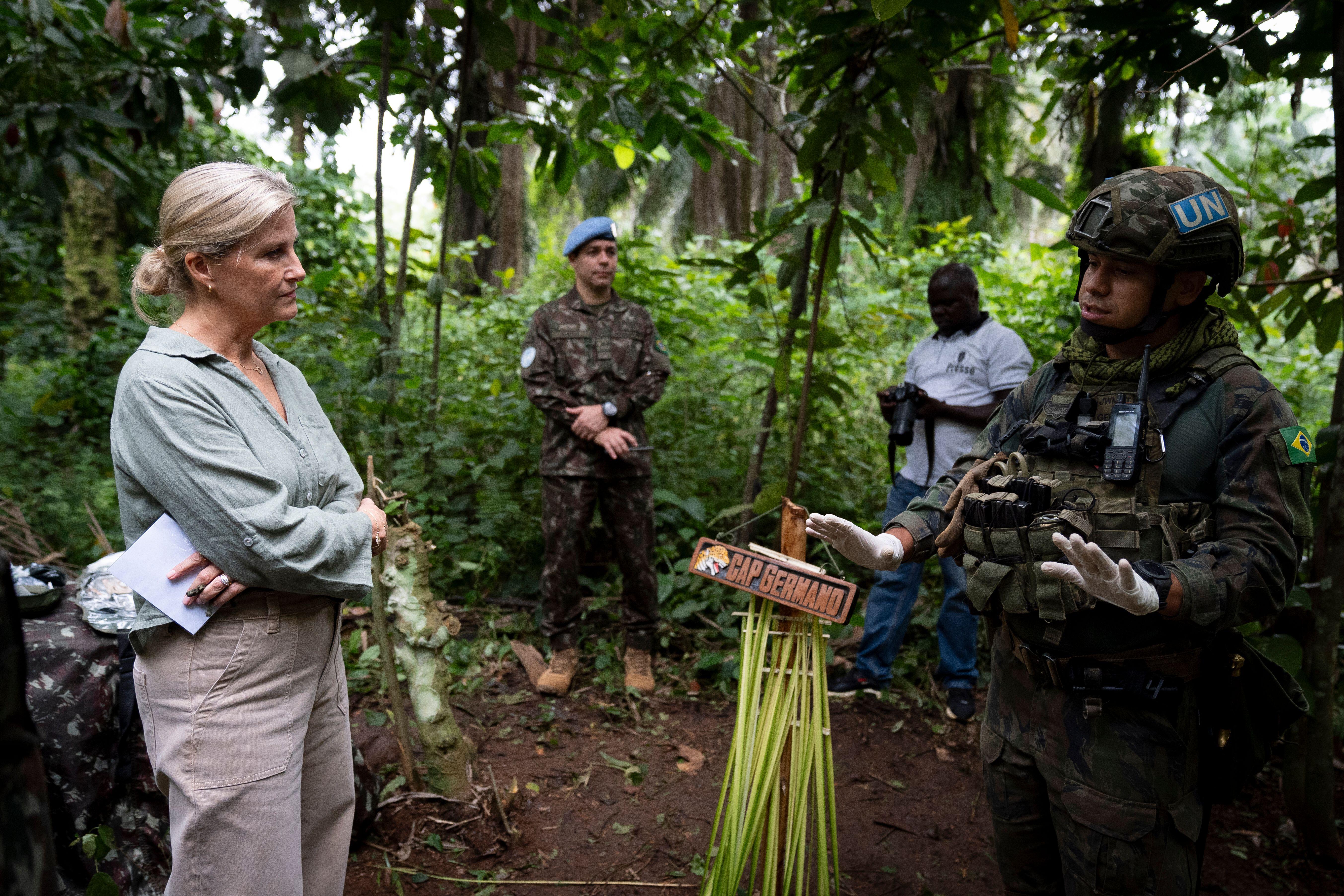 Duchess Sophie wearing a green top and khakis in the jungle with men in military gear