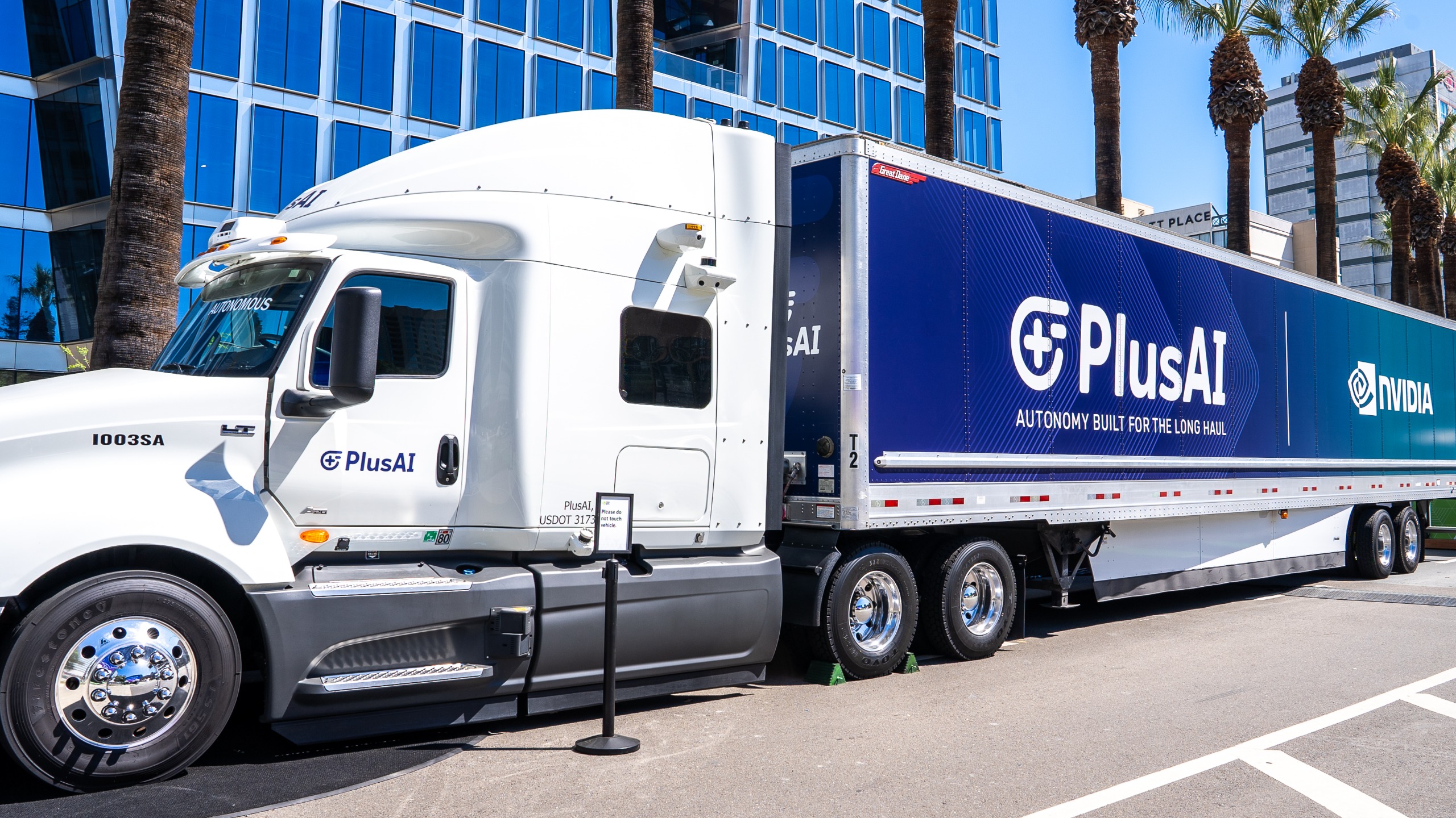 A PlusAI autonomous truck featuring PlusAI and Nvidia branding on the trailer