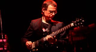 Robert Fripp of King Crimson takes a solo during the prog band's 1984 performance at the Poplar Creek Music Theater in Hoffman Estate, Illinois.