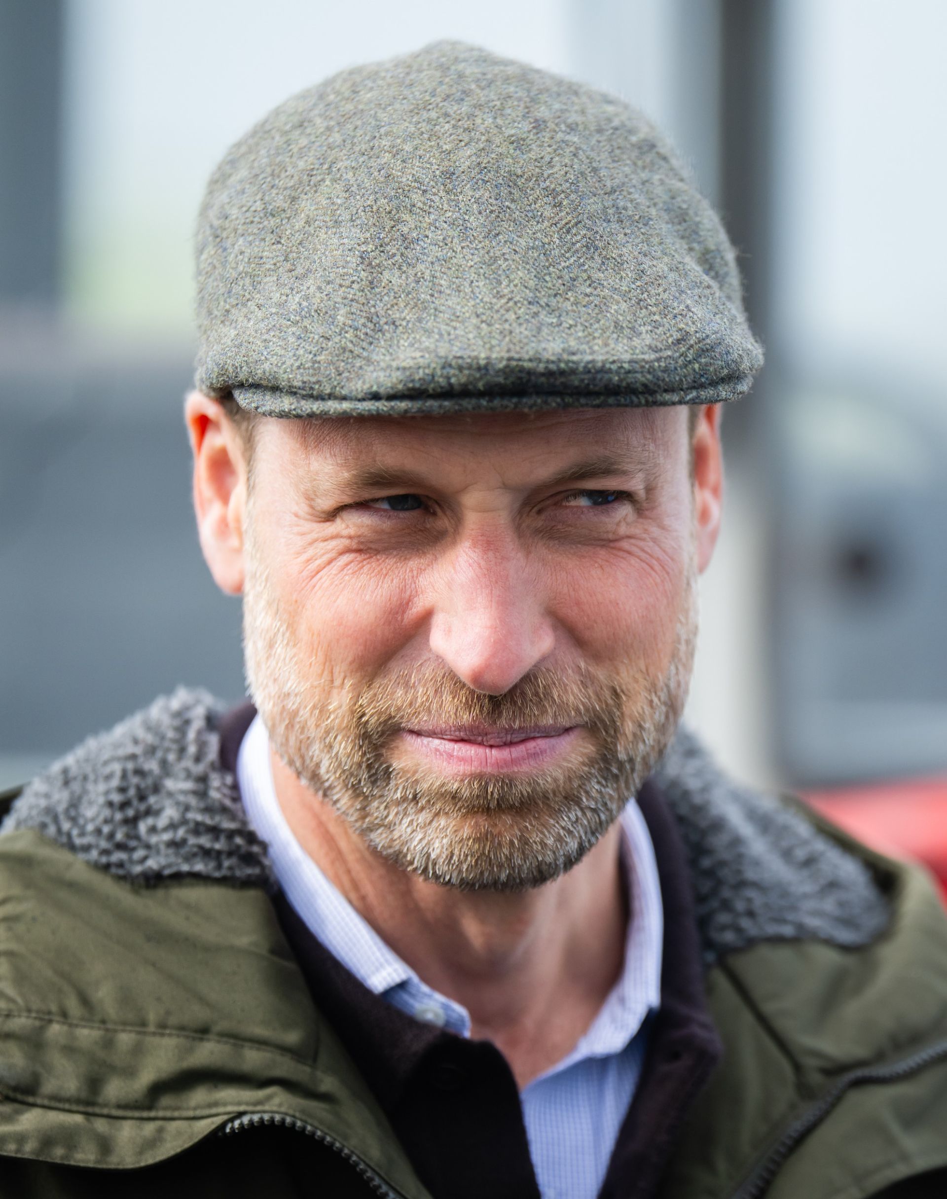 Prince William wears a flat cap with a green hooded coat to visit the Scottish island of Bute with Princess Kate