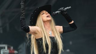 Shania Twain on stage in black at Glastonbury 2024