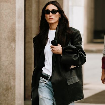  street style star wears white t-shirt, black blazer, and black sunglasses while attending milan spring/summer 2025 fashion week 