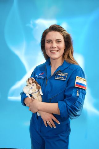 Roscosmos cosmonaut Anna Kikina poses with a Mattel Barbie doll modeled in her image. The one-of-a-kind doll is aimed at inspiring young girls to pursue the professions of their dreams.