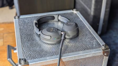 A pair of Positive Grid Spark Neo Core headphones on a silver flight case