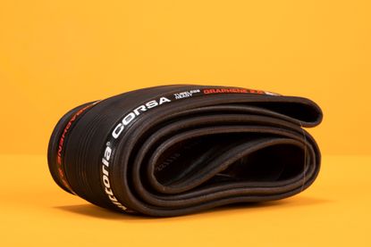 The Vittoria Corsa G2.0 TLR folded and on an orange backdrop