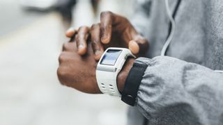 Best smartwatches of 2022: image shows athlete looking at smartwatch