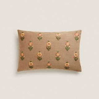 A brown pillow cover with embroidered daisies, for Zara Home's summer sale.