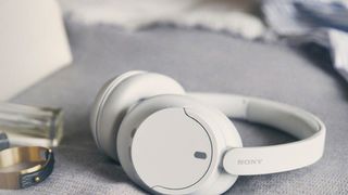 Sony WH-CH720N on a couch cushion