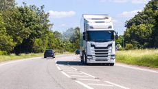 Articulated lorry driving along a British road in daylight.