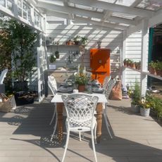 A pretty seating area underneath a pergola made out of windows