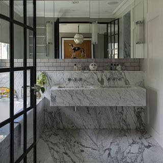 bathroom with veined marble floor and washbasin