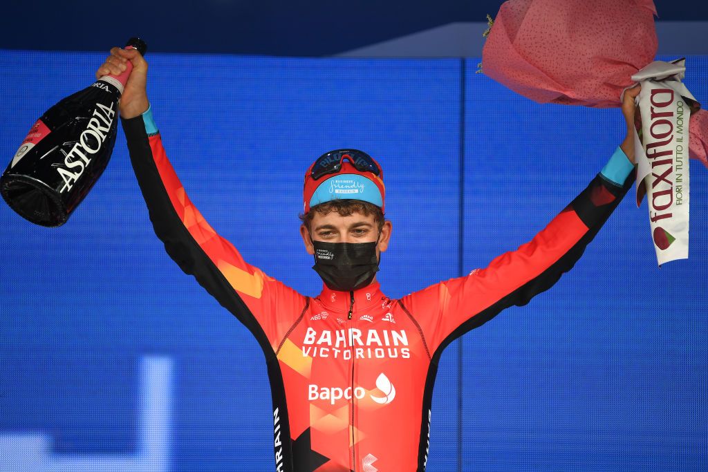 ASCOLI PICENO SAN GIACOMO ITALY MAY 13 Gino Mader of Switzerland and Team Bahrain Victorious stage winner celebrates at podium during the 104th Giro dItalia 2021 Stage 6 a 160km stage from Grotte di Frasassi to Ascoli Piceno San Giacomo 1090m Mask Covid safety measures Champagne Flowers girodiitalia Giro UCIworldtour on May 13 2021 in Ascoli Piceno San Giacomo Italy Photo by Tim de WaeleGetty Images
