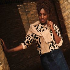 Model wearing a black and white leopard print jumper and denim skirt sold at JD Williams