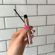 A handheld view of the Patrick Ta Major Brow Lamination Gel against a white tiled background