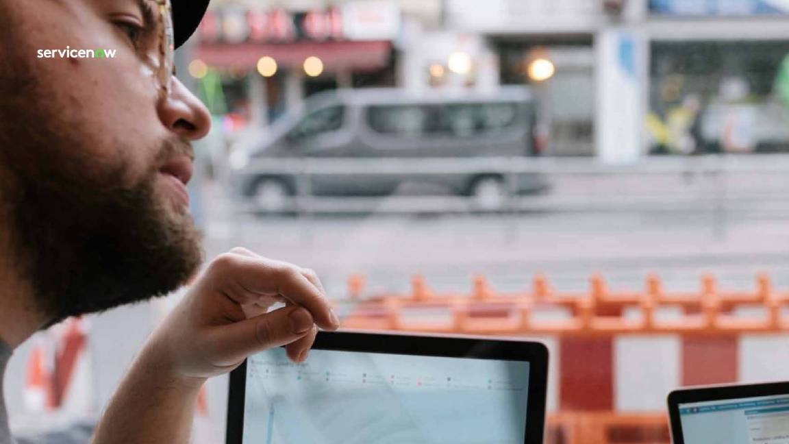 Developer in a cafe looking at a laptop screen