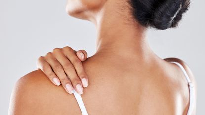 woman massaging her shoulder from chronic pain