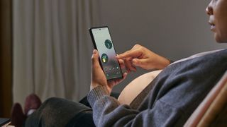 Google Pixel 6a official imagery, woman in chair using the phone