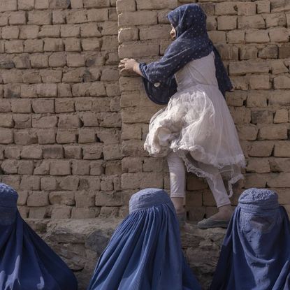 Women wait to see a doctor at a mobile health clinic in Bagrami District, Kabul Province, Afghanistan.