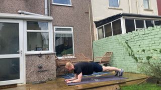 Fit&Well fitness writer Harry Bullmore performing a plank as part of an Arnold Schwarzenegger bodyweight workout challenge