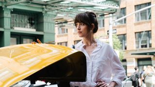 Dakota Johnson standing by a cab in Materialists