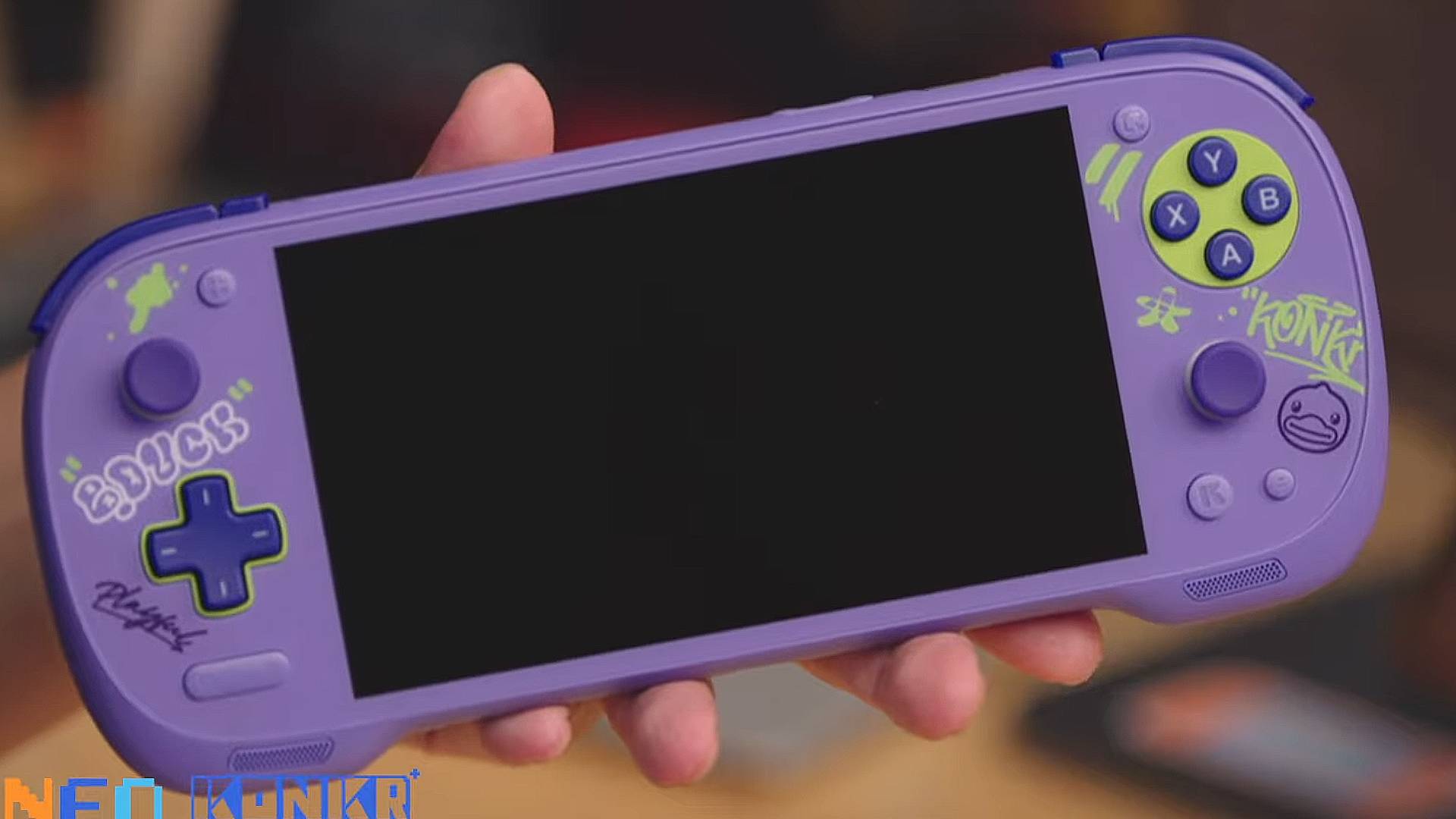 Hand holding Konkr Fit Pocket in purple with duck graffiti on front.