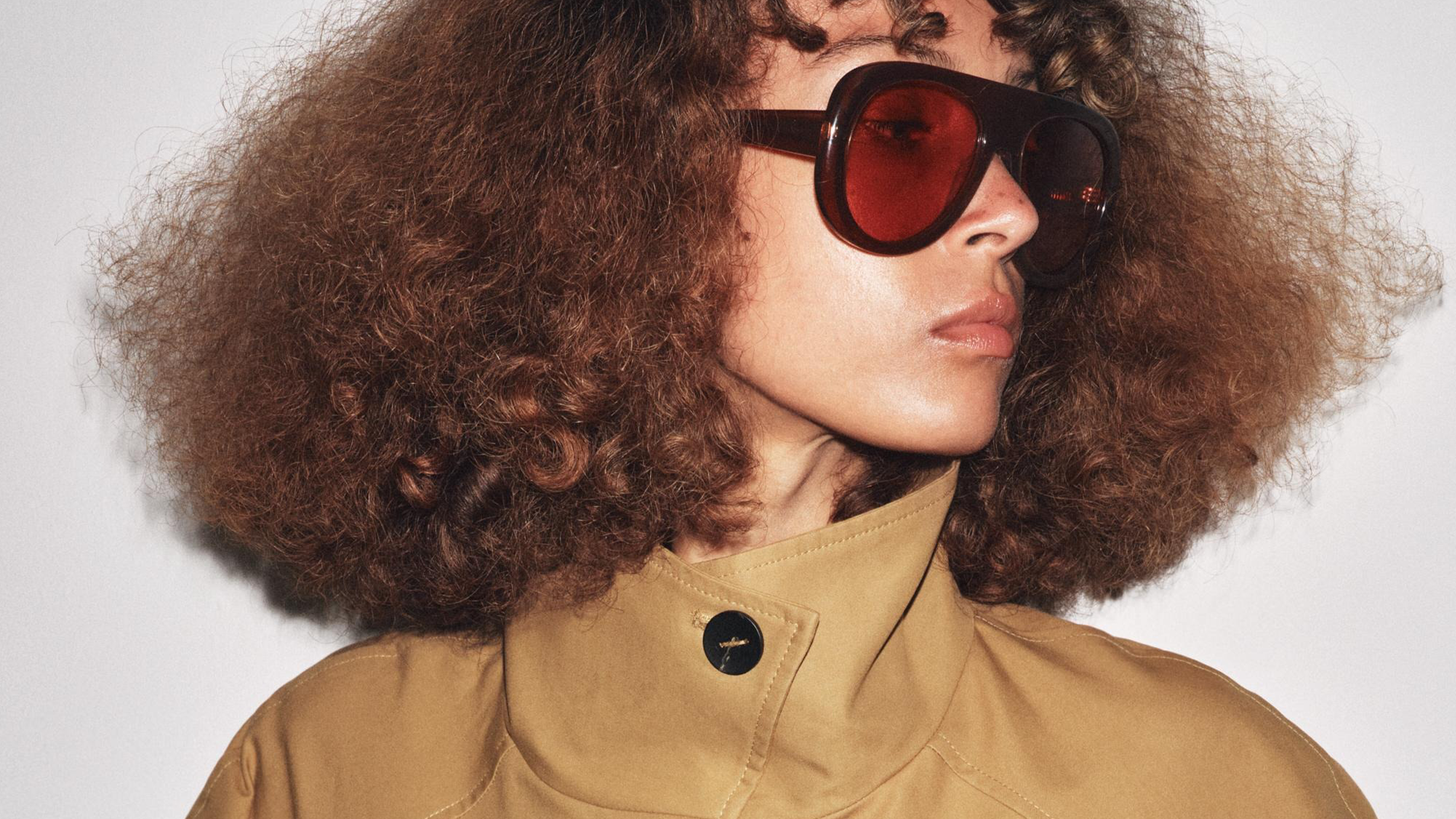 Zara model wearing sunglasses and cropped trench coat.