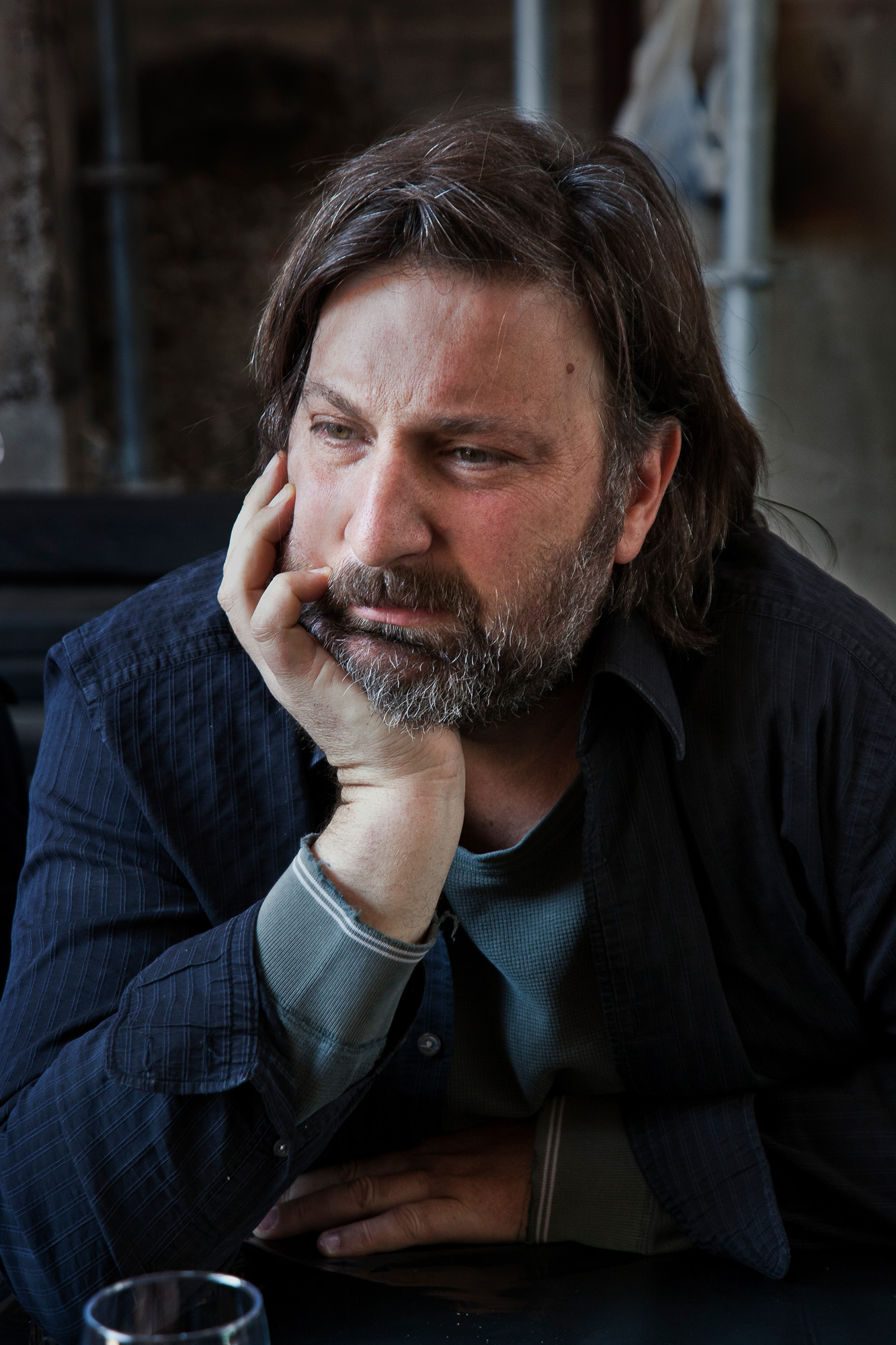 portrait of Smiljan Radic with his head resting on his hand