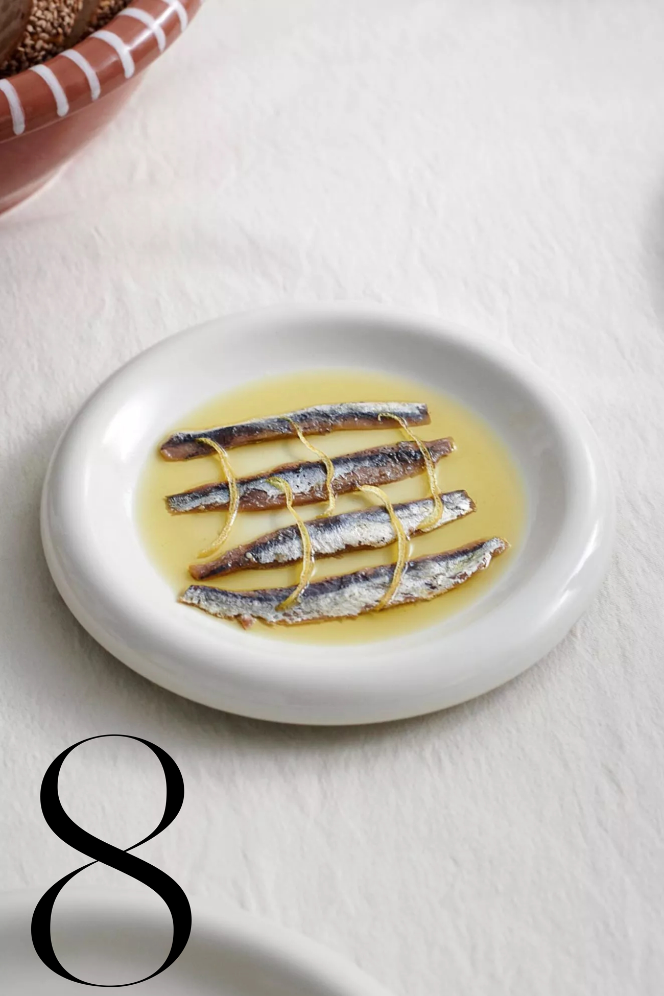 sardines on a white plate in sauce