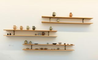 Wooden shelves displaying jugs