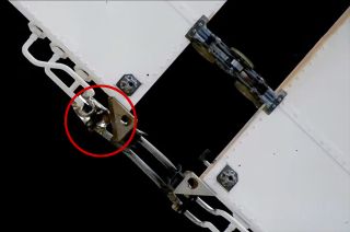 closeup of a small droplet of coolant, circled in red, outside the international space station.
