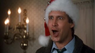 Chevy Chase wearing a Santa hat and yelling with his mouth open in Christmas Vacation