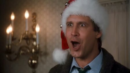 Chevy Chase wearing a Santa hat and yelling with his mouth open in Christmas Vacation