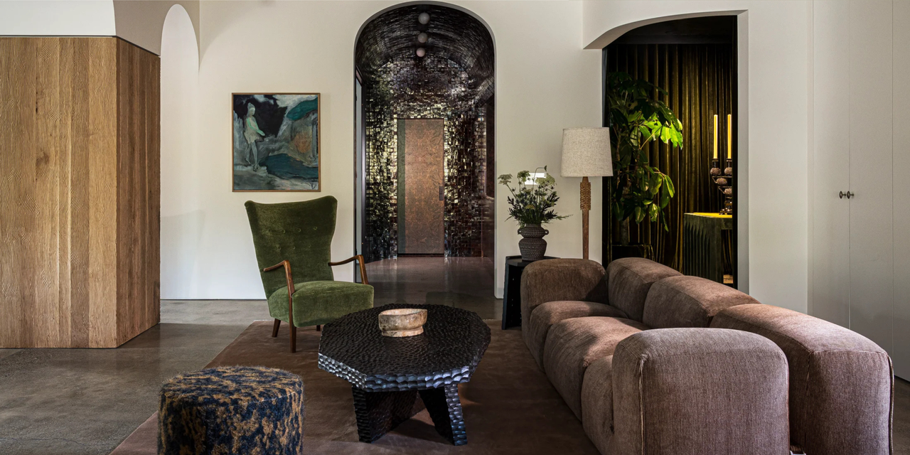 living room with a brown couch, green chair, and earth colored décor 