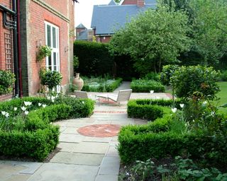 stone path and walkway edged with clay pavers