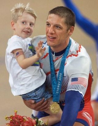Marty Nothstein holds his son Tyler after winning the gold medal in Sydney