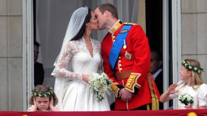 Prince William, Duke of Cambridge and Catherine Middleton, Duchess of Cambridge kiss on the balcony of Buckingham Palace following their wedding on April 29, 2011