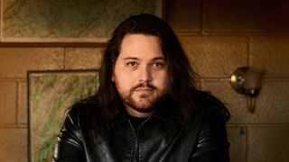 Wolfgang Van Halen seated at a desk