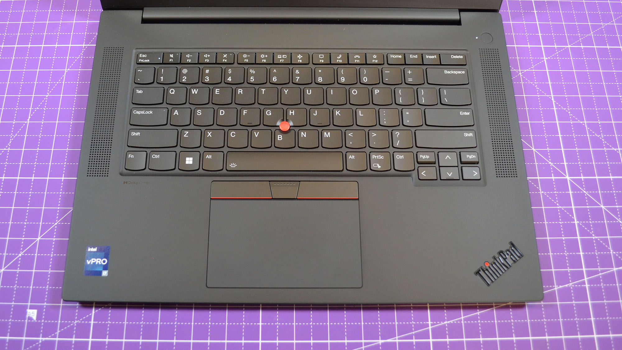 A Lenovo ThinkPad P1 Gen 6 on a table with a purple desk mat underneath