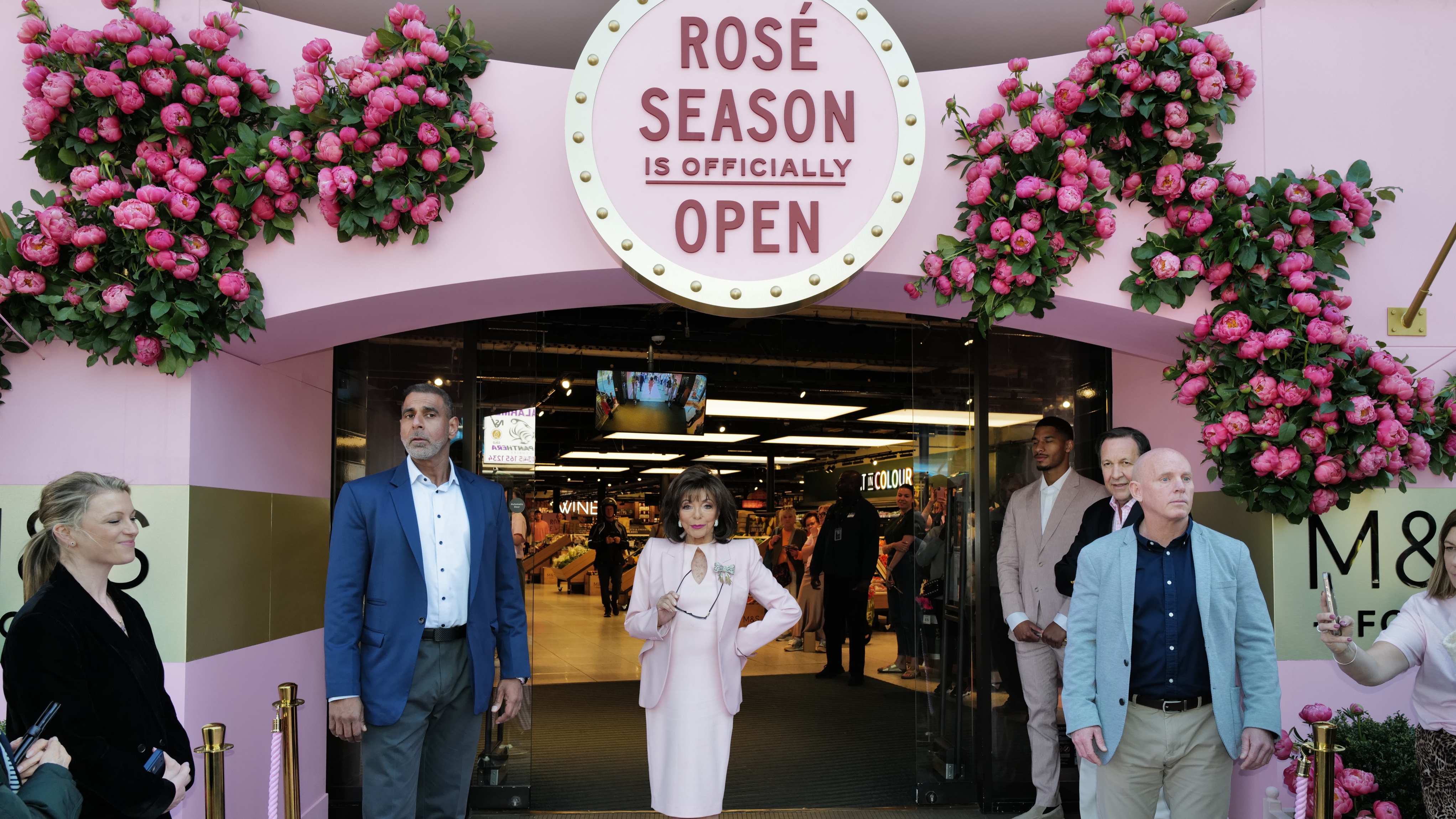 M&amp;amp;S opening of rose season with Joan Collins standing in front of an M&amp;amp;S store