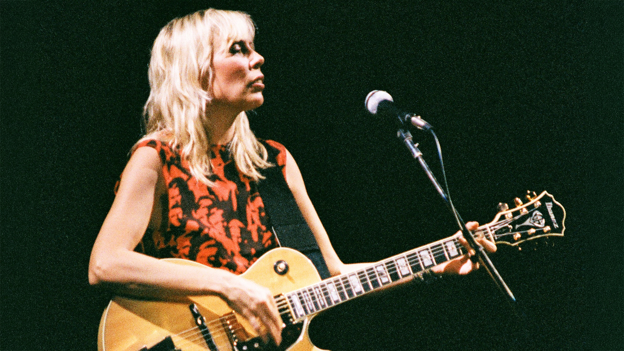 Joni Mitchell performs on stage at Wembley Arena on April 23rd, 1983 in London, United Kingdom. She plays an Ibanez guitar.