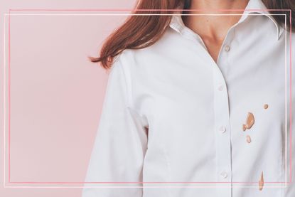 A woman wearing a white shirt with a foundation stain